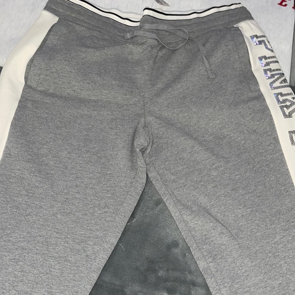 Pink sweatpants with sequins pink down on one side of the leg.NWT size L